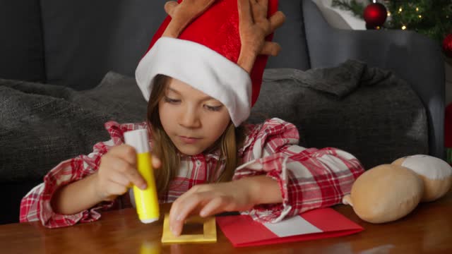 Girl Making a Santa Christmas Card.