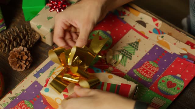 Hands Adding The Final Touch to Gift.