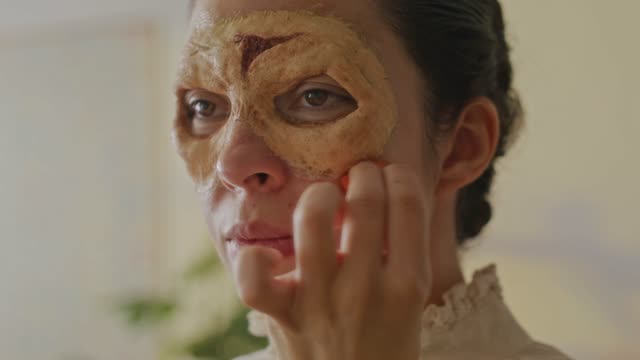 Woman Applying Monster Makeup.