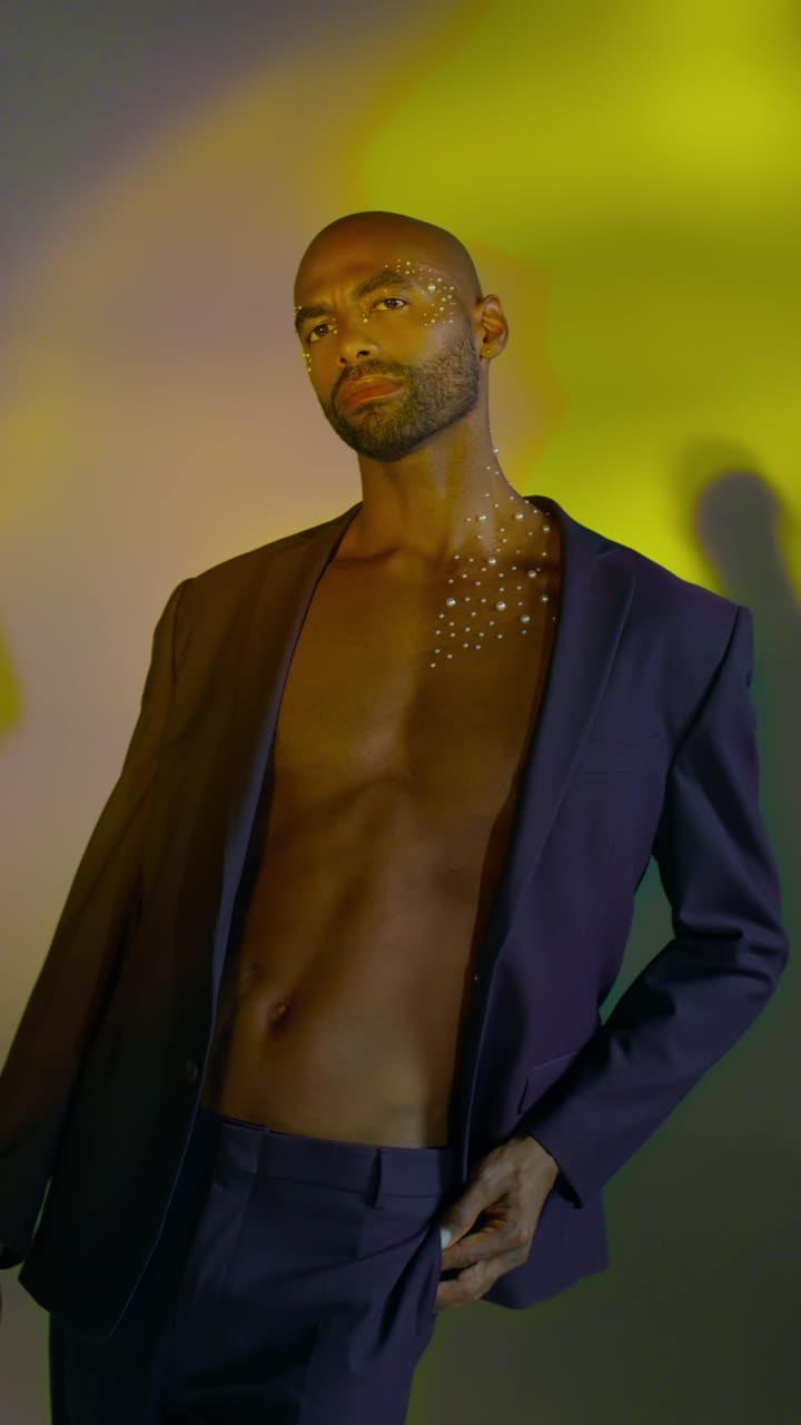 Model in stylish open jacket against colorful backdrop - Free Stock Video