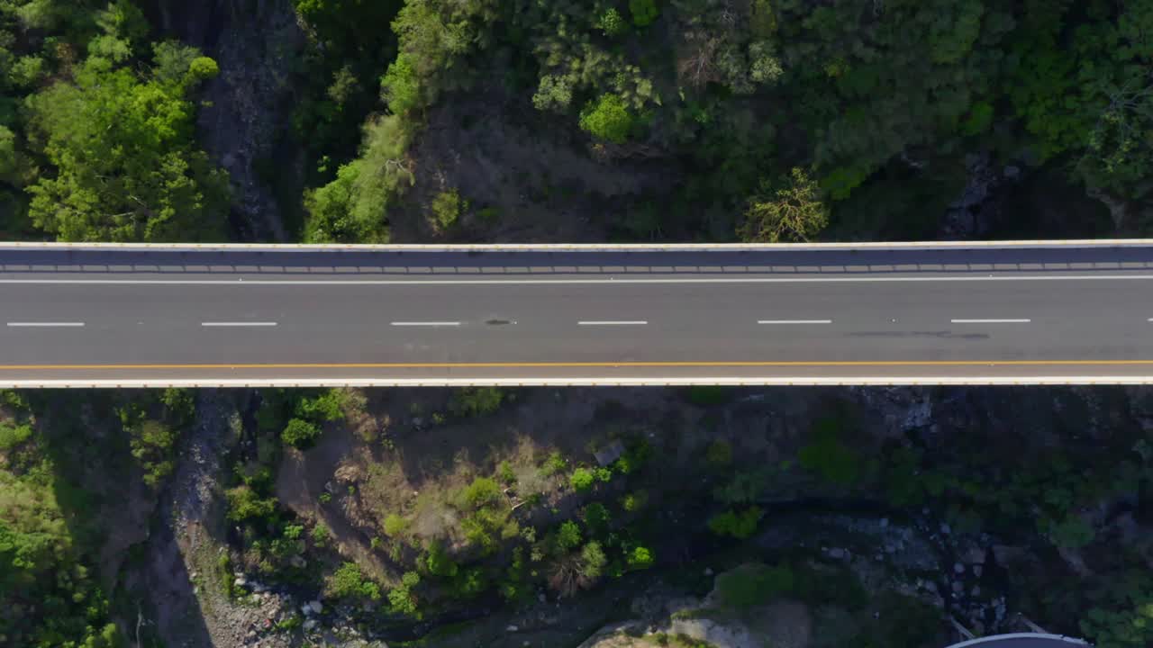 Aerial view of bridge over lush green landscape - Free Stock Video