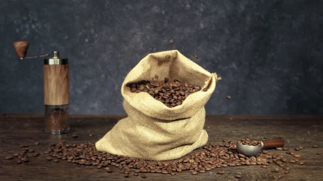 Burlap sack overflowing with coffee beans.