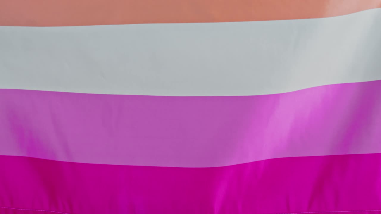Close up of the lesbian pride flag with pink, white, and orange stripes ...