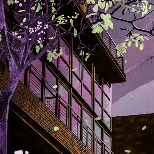 Tree with pink blossoms in front of a city building