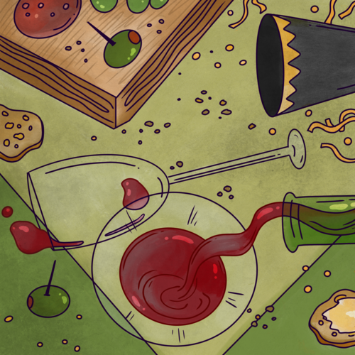 Red wine spilled on a table covered in party hats and food crumbs