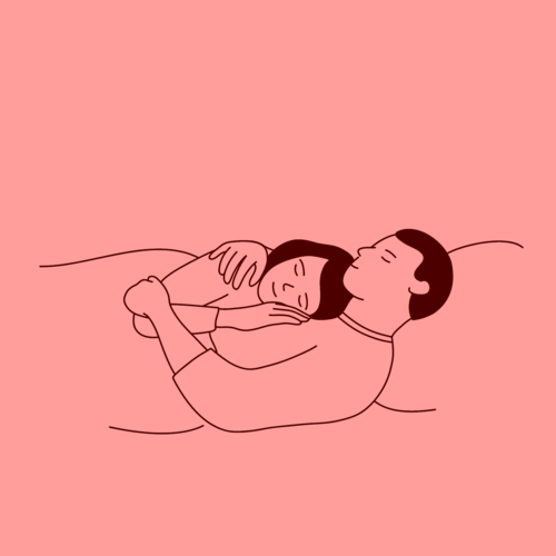 Couple lying in bed, embracing