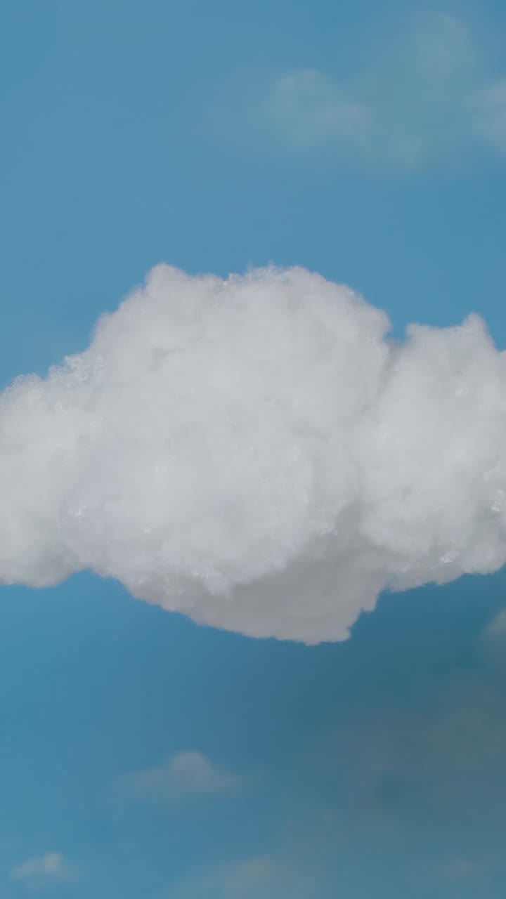 Fluffy white cloud against a clear blue sky - Free Stock Video