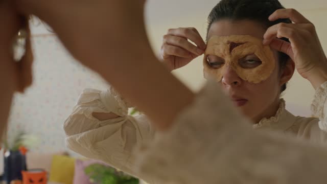 Makeup Artist Adjusting Monster Prosthetics.