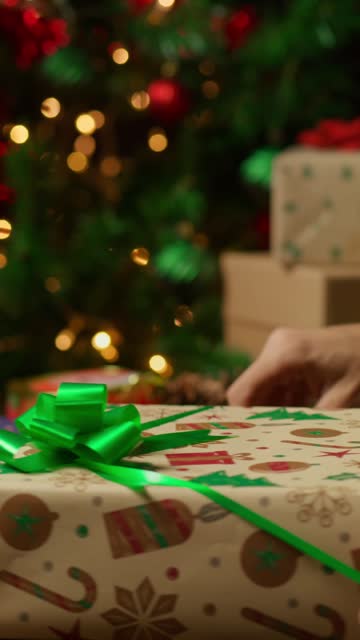Hands Wrapping a Christmas Gift .
