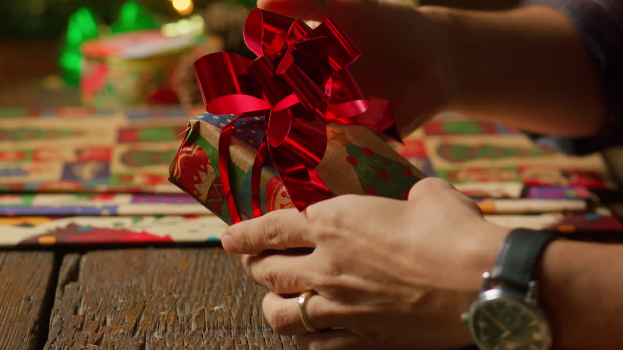 Person Arranging Gift Wrapping Details.