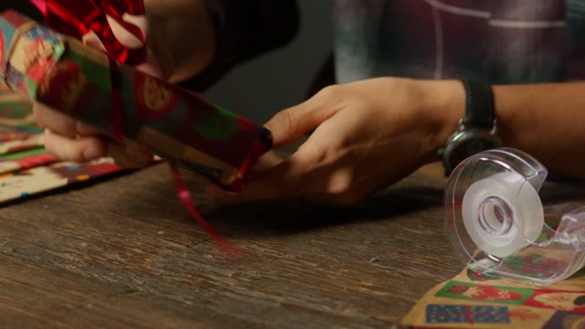 Hands Wrapping Christmas Gift.