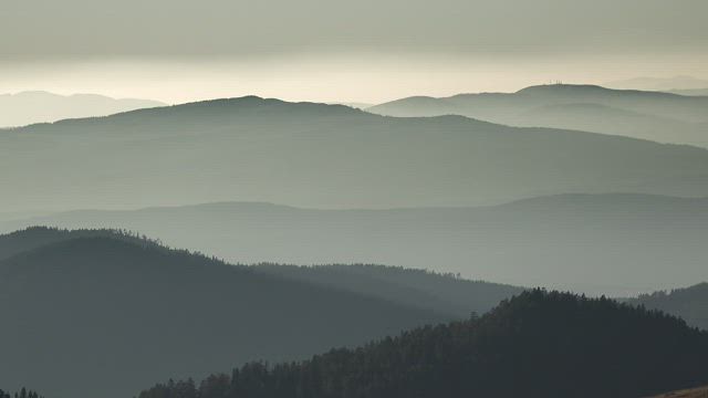 Silhouette of hills and mountains in the distance.