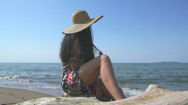 A woman staring at the ocean  .