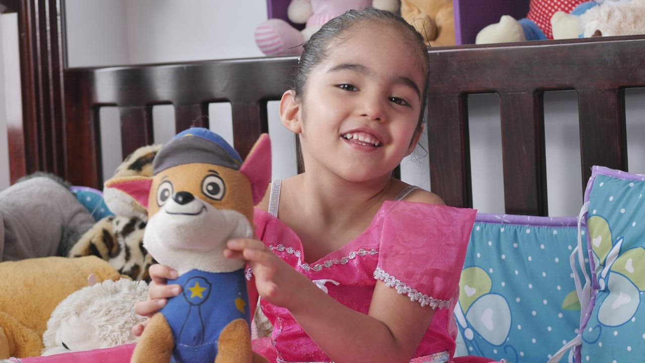Little smiling girl with a stuffed toy - Free Stock Video