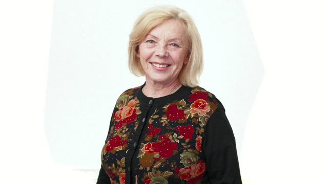 Older woman showing the thumbs up.