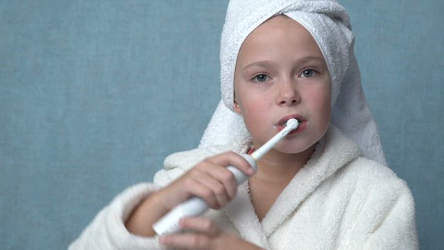 Child brushing their teeth.