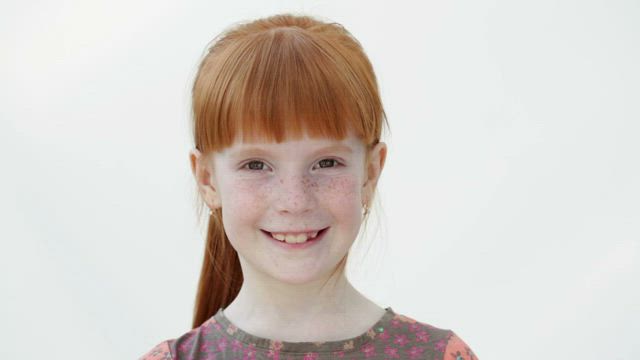 Young girl winking.