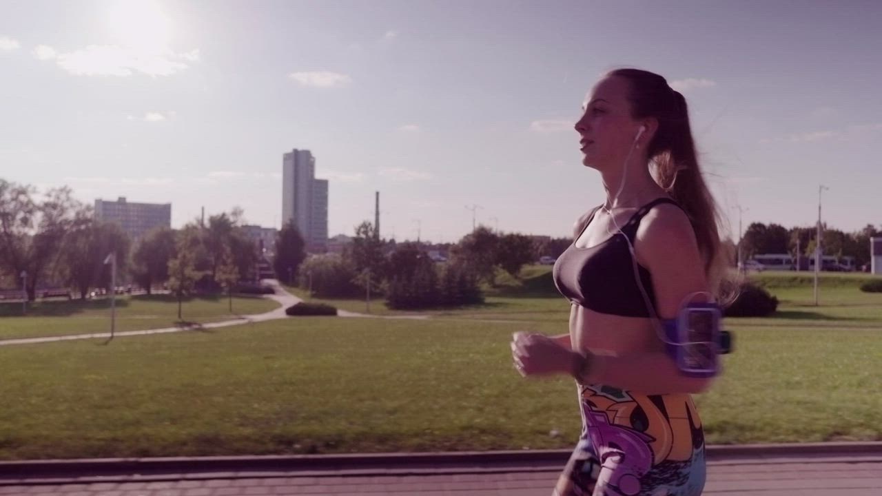 Woman running through a park - Free Stock Video