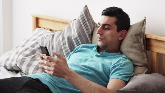 Young man relaxing with his phone.