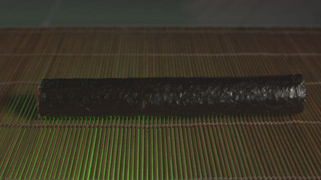 Cutting a roll of Sushi.