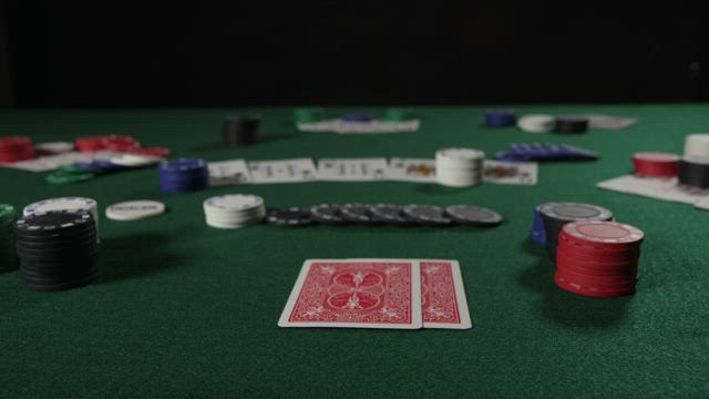 Poker player checking their cards.