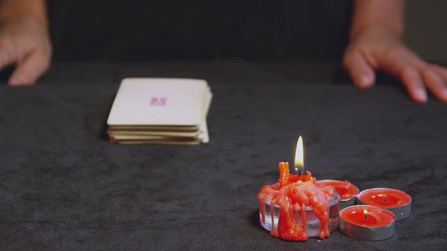 Woman holding Tarot Cards.