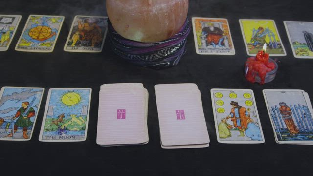 Fortune reader preparing cards.