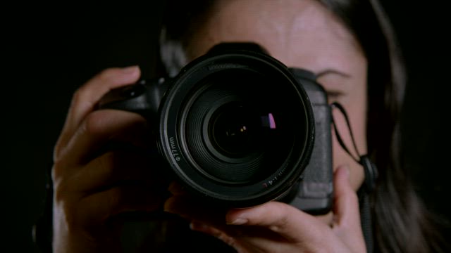 Woman using a camera.