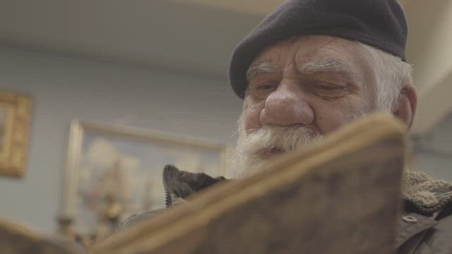 Older man reading a book.