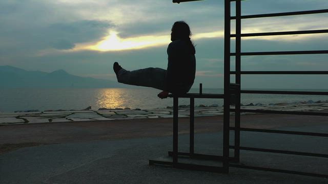 Man exercising with effort on the beach.