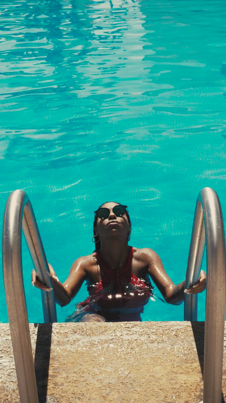 Woman in swimwear getting out of a pool - Free Stock Video
