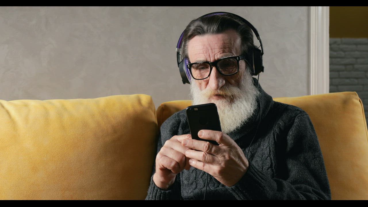 Elderly man looking at his smartphone