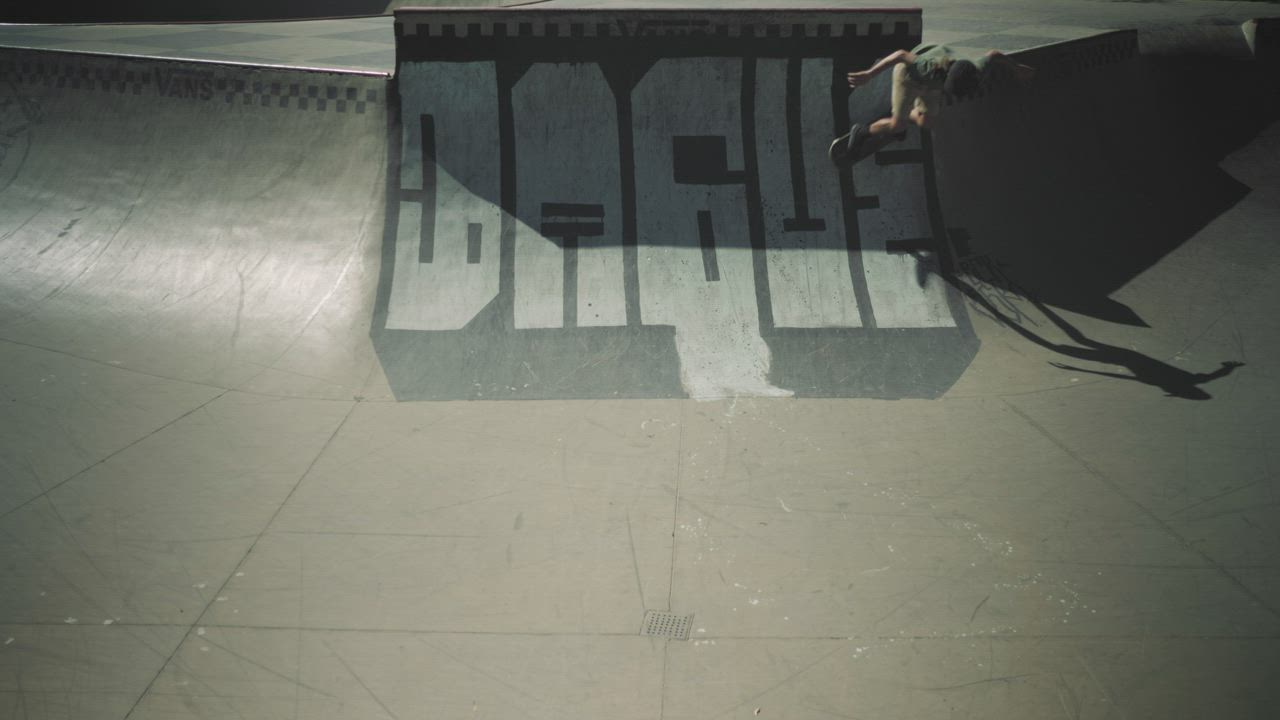 Skater doing skate tricks on a half pipe track - Free Stock Video