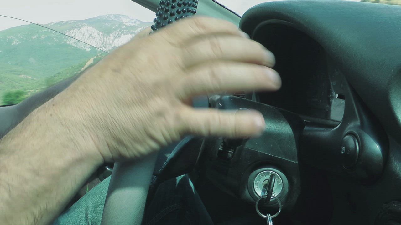 Car driver activating windshield wipers - Free Stock Video