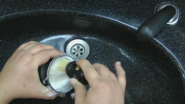 Barber preparing shaving foam.