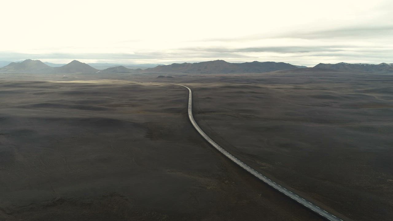 Aerial view of a road and the mountains - Free Stock Video