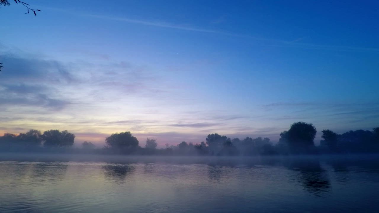 Sunrise with beautiful colors, fog, and the lake - Free Stock Video