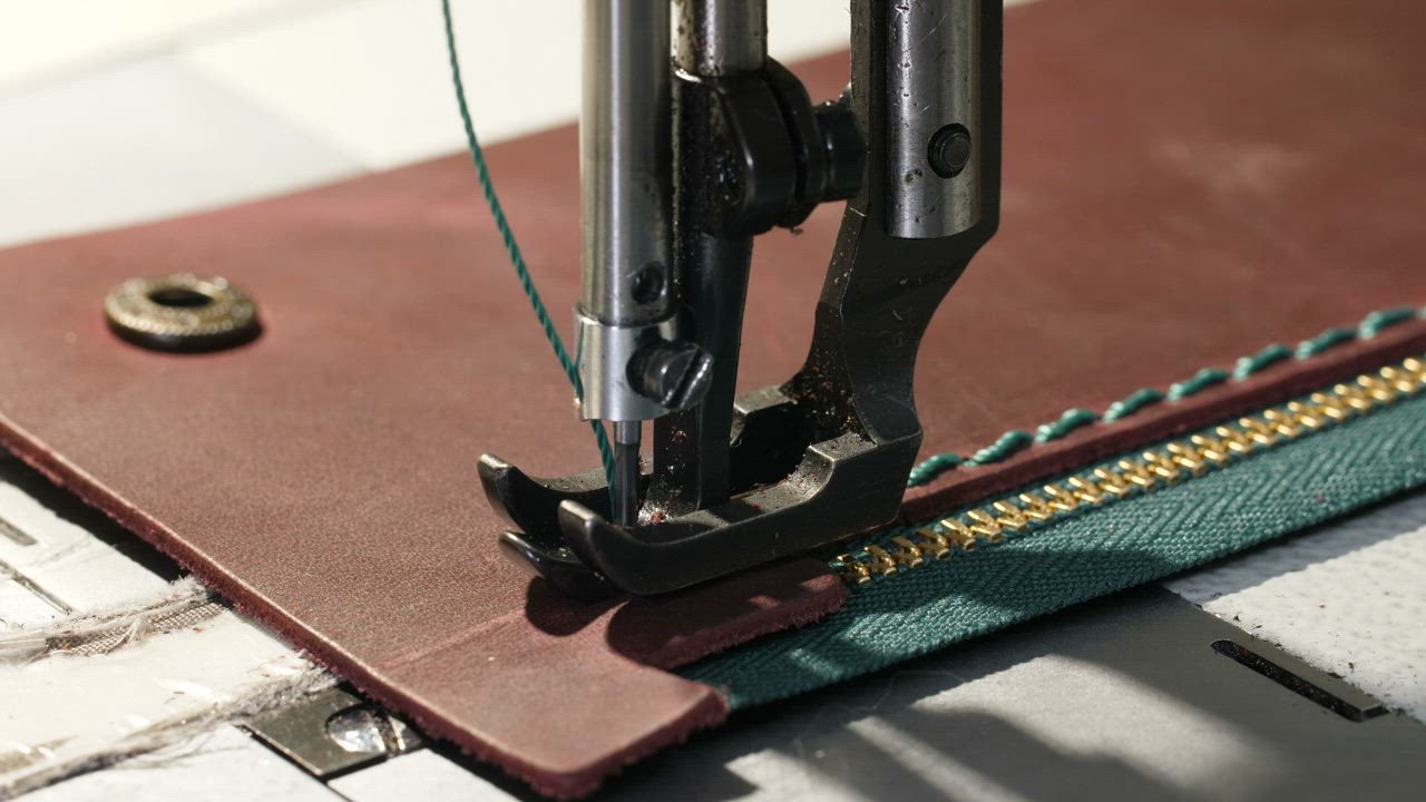Stitching a wallet using a sewing machine - Free Stock Video