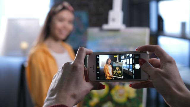 Taking a photo of an painter.