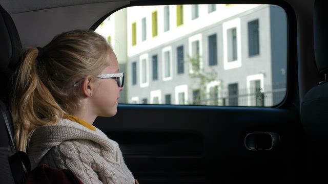 Taking her child to school.