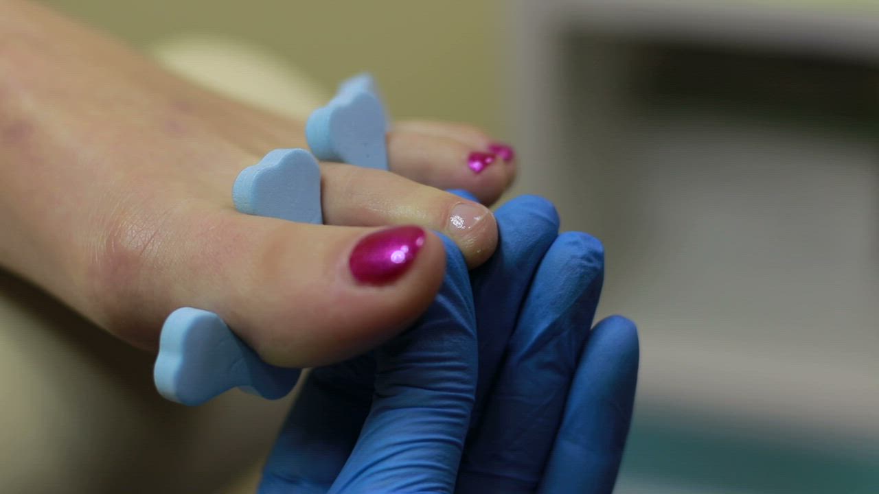 Applying color to nails - Free Stock Video