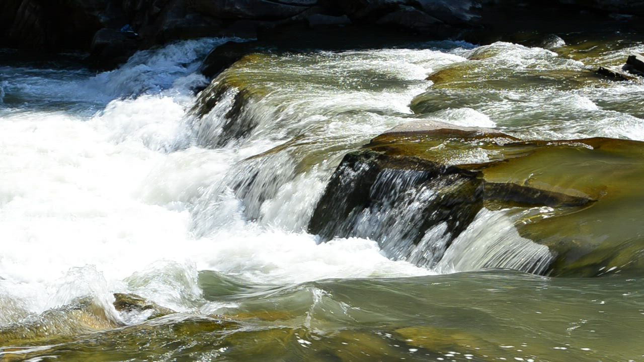 River flowing over large rocks - Free Stock Video