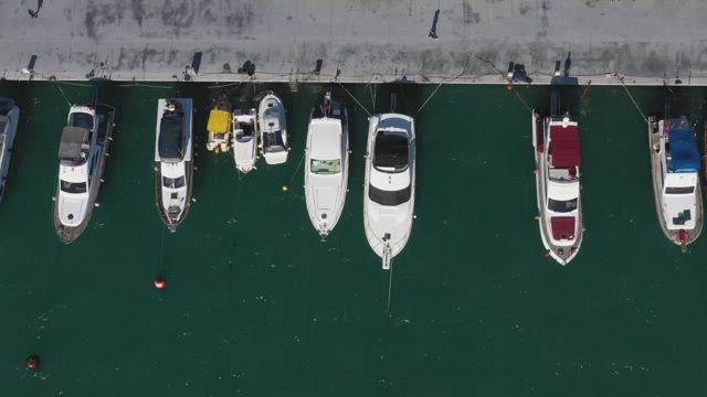 Boats along the harbor wall.