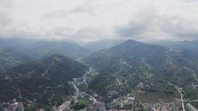 Buildings between two mountains.