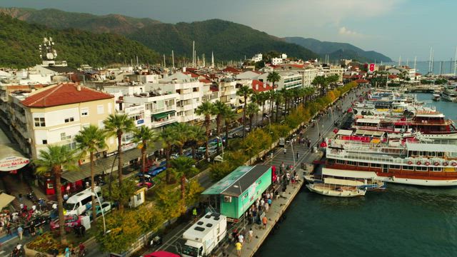 Seaside buildings and large boats.