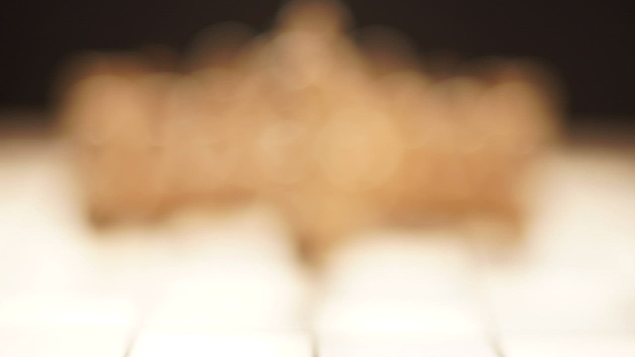 A wooden chess piece in shallow focus