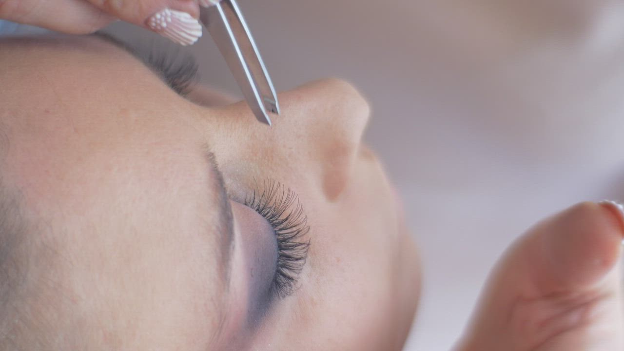Working on a woman's eyelashes - Free Stock Video