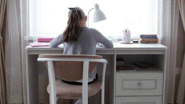 Working in her bedroom.