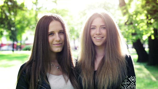Two teenagers laughing at the camera.