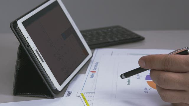 Using a tablet calculator.